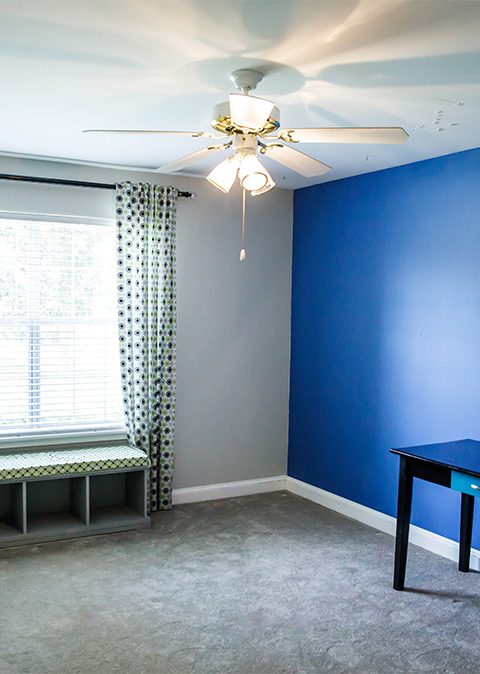 Empty Room with a blue accent wall in a House after child moves out and parent is an empty nester