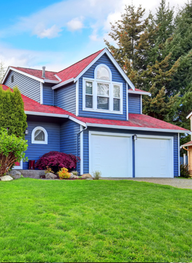 Beautiful curb appeal with blue exterior paint and red roof.